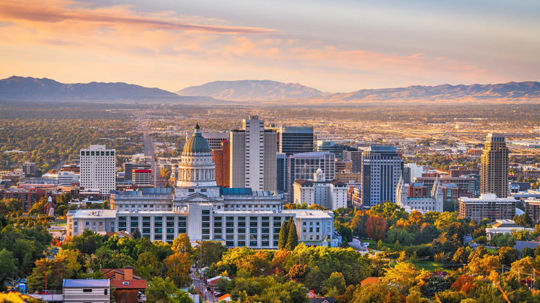 Salt Lake City skyline at dawn surrounded by mountains and trees