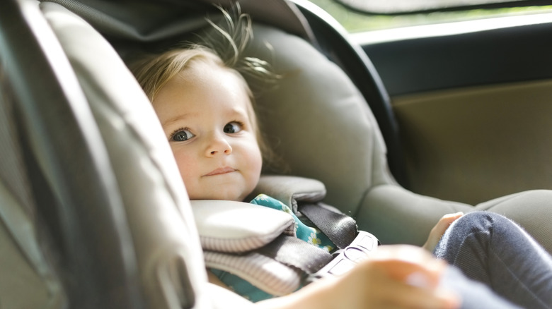 a child in a car seat