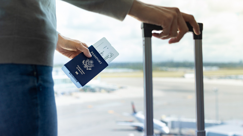 traveler holding passport in airport
