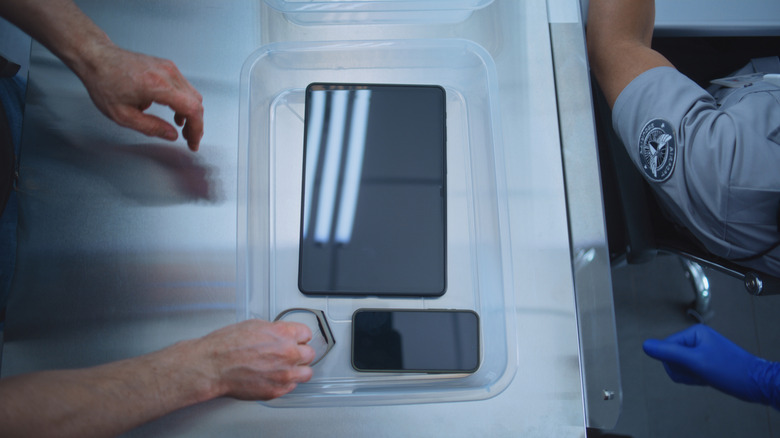 placing electronics in a scanner bin
