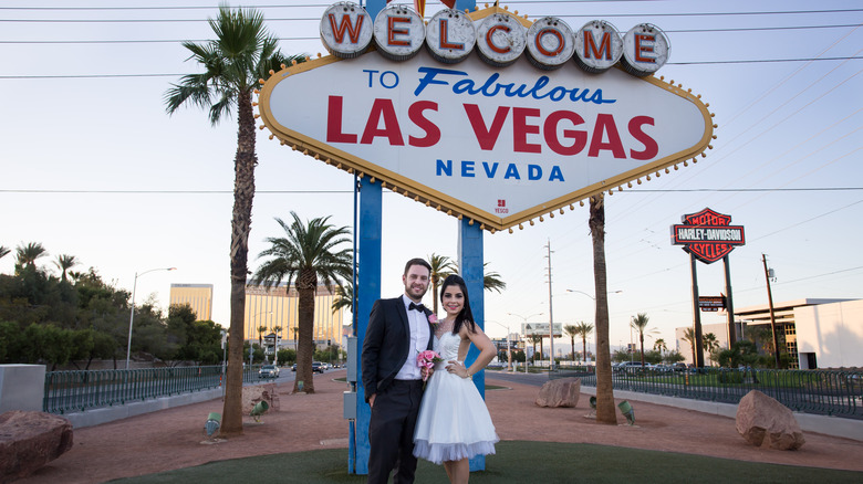 newlyweds at Las Vegas sign
