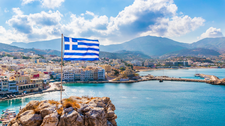 Greek flag and harbor on Karpathos