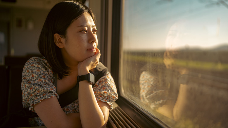 Asian woman train window
