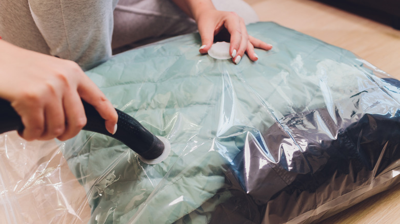 Person using vaccuum bag