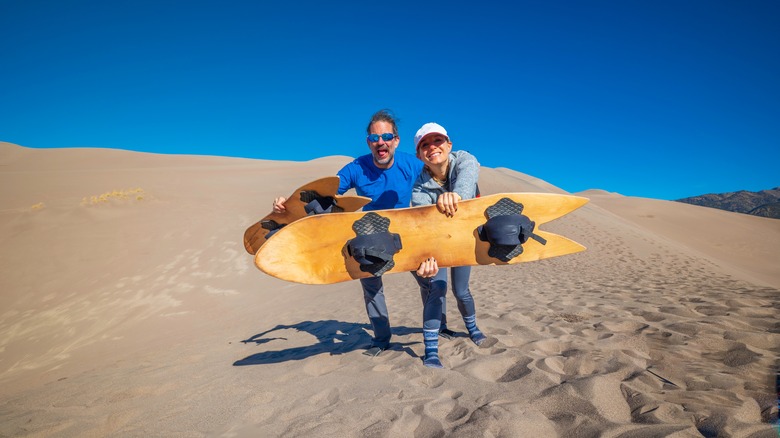 A couple sandboarding