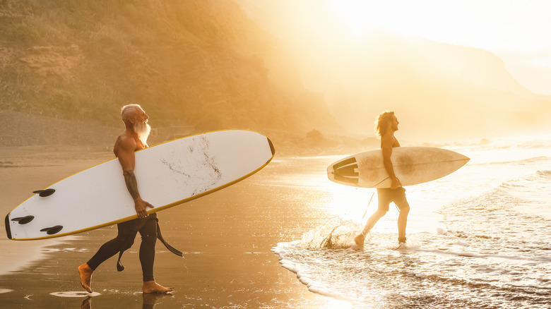 two surfers with different boards