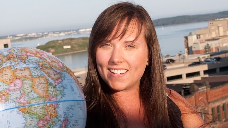 Cailin holds a globe