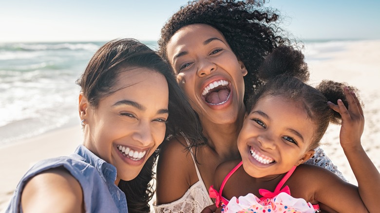 happy family smiling at beach