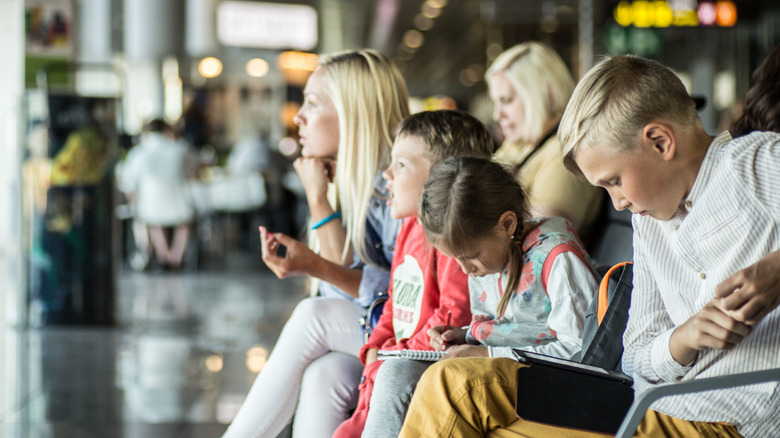 family sitting in airport