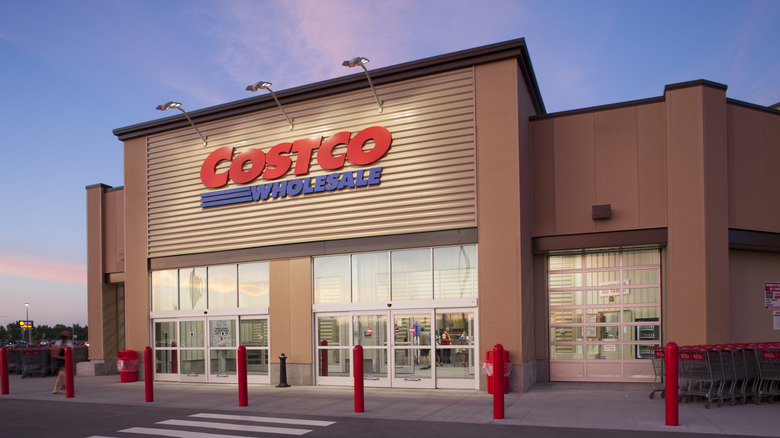 Costco Wholesale storefront at dusk.