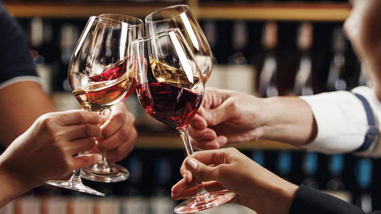 Four wine glasses toasting