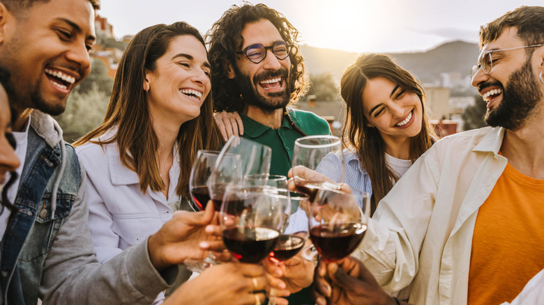 A group of people toasting with wine