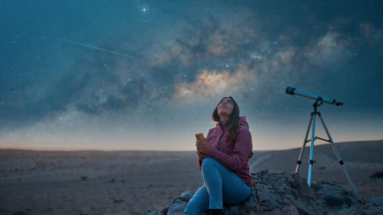 woman stargazing in desert