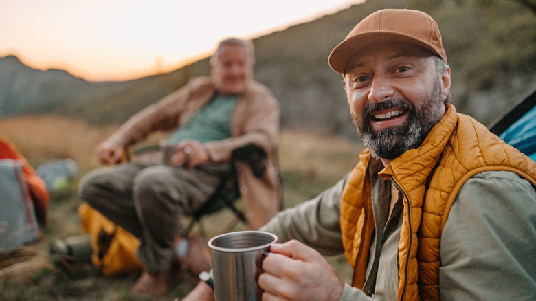men drinking coffee at camp