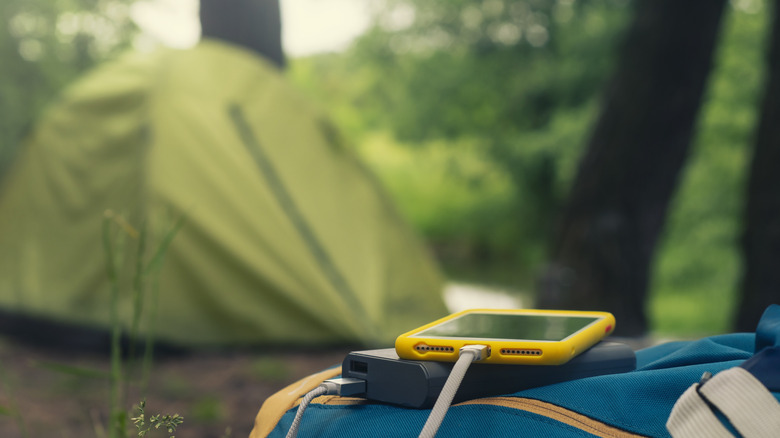 Phone charging in a power bank while tent camping
