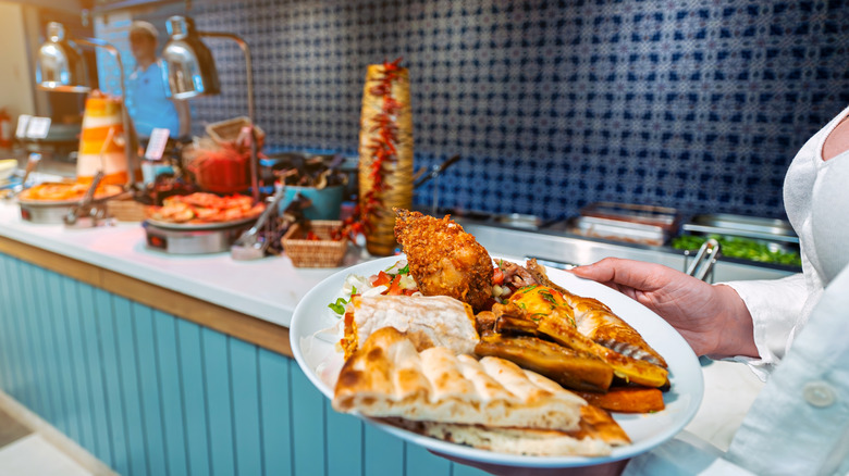 person with plate at buffet