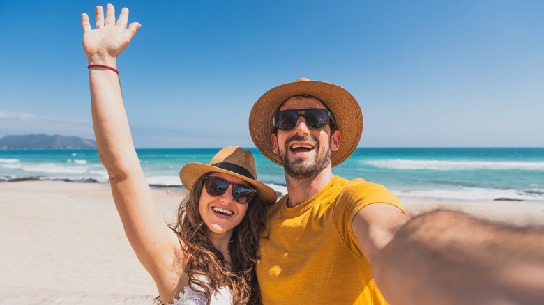 Couple smiling on a sunny beach