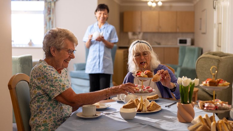 two elderly women enjoying afternoon tea