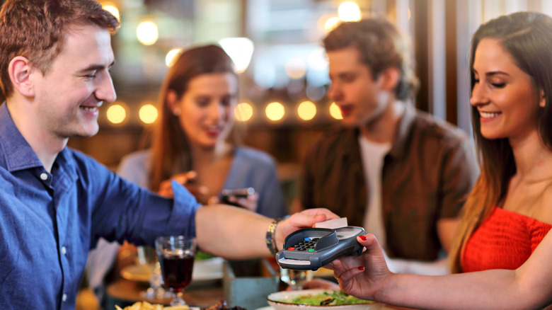 Friends paying a restaurant bill