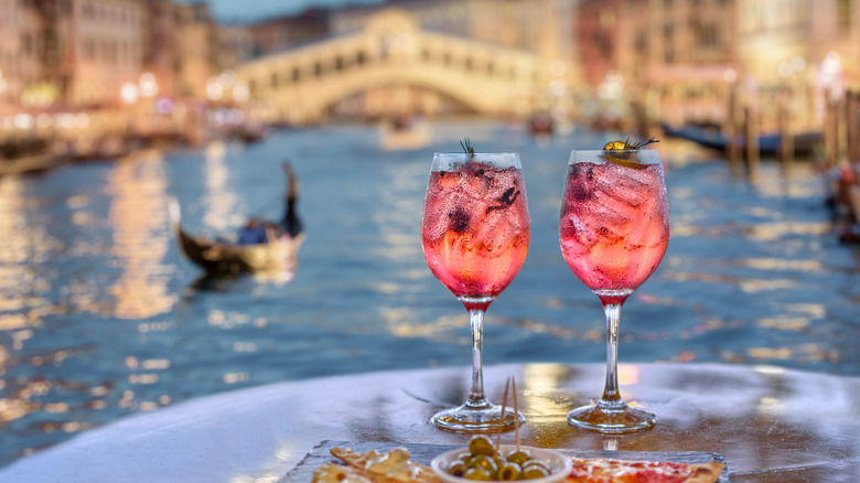 drinks and appetizers on table facing a canal in Venice