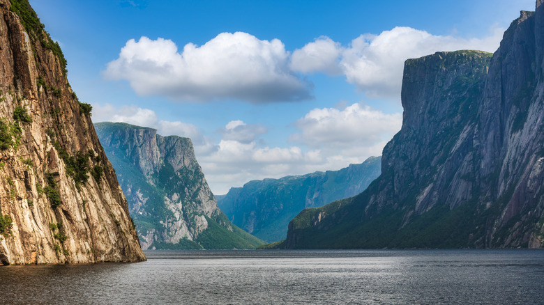 Mountains standing tall over the fjord of Western Brook Pond in Gros Morne National Park, Newfoundland, Canada