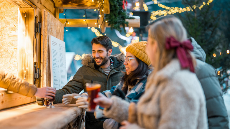 A group of friends getting drinks at Christmas market