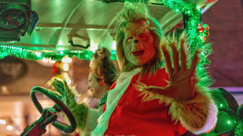The Grinch character sitting on parade float