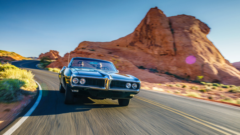 A convertible driving down a highway during a road trip through the US