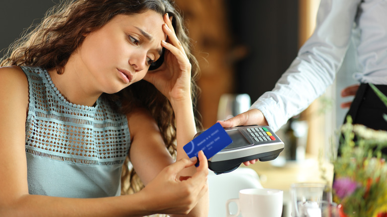 Woman paying restaurant bill