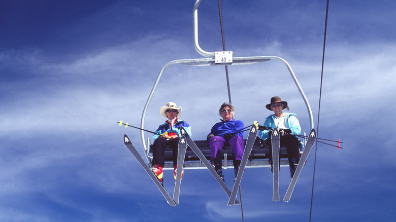 happy skiers on a chairlift bluebird day