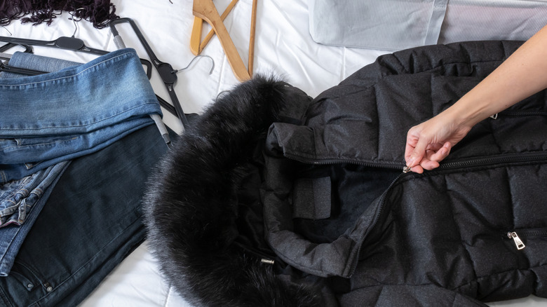 Packing a winter coat.