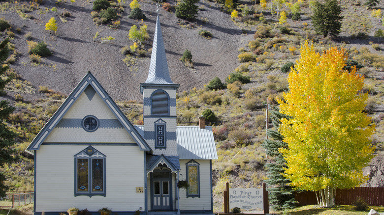 Church and yellow aspen tree in Lake City, Colorado