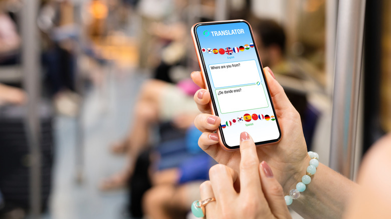 a woman's hands holding a phone with a translation app