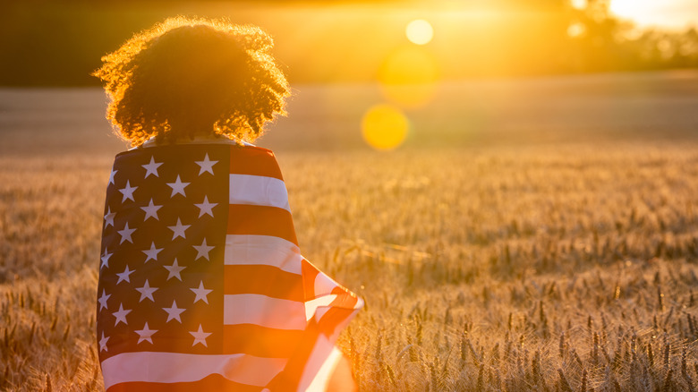 Girl wrapped in the American flag