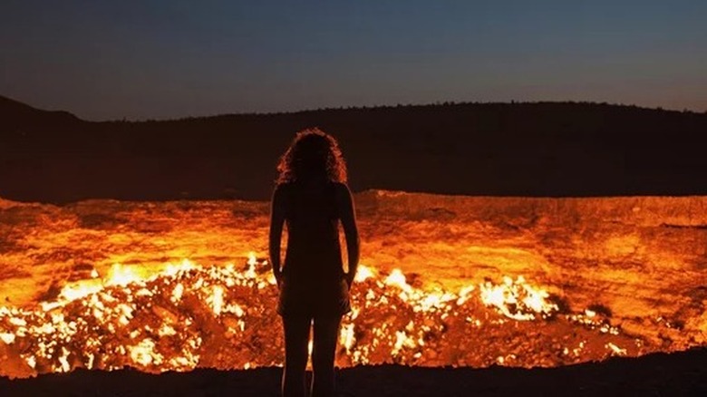 woman standing over volcano