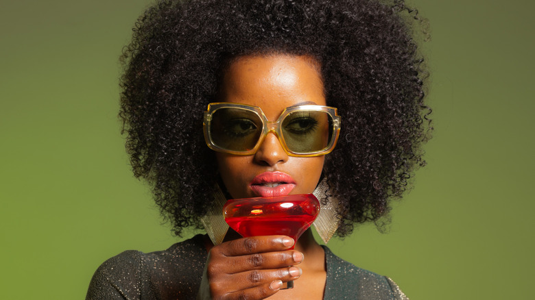 woman sunglasses drinking red cocktail