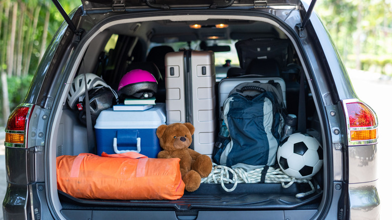 the trunk of a car packed with camping essentials