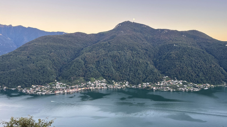 Aerial view of a lakeside town surrounded by mountains