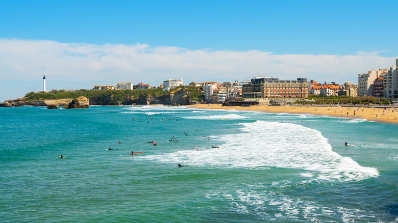 view over turquoise water with surfers at beach in France