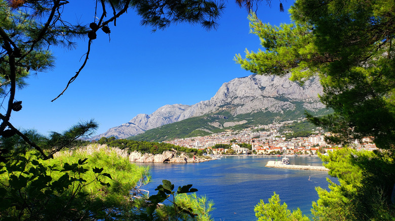 Mountain view from cliff overlooking blue water