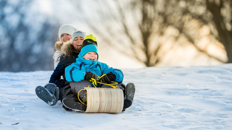 Kids riding on a toboggan