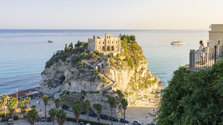 The Sanctuary of San Maria Dell'Isola sitting on a rocky outcrop above the sea
