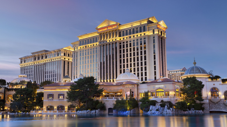 Luxurious hotel Caesars Palace at twilight, located at the Paradise area in the Las Vegas Strip, as seen over the Bellagio Lake.