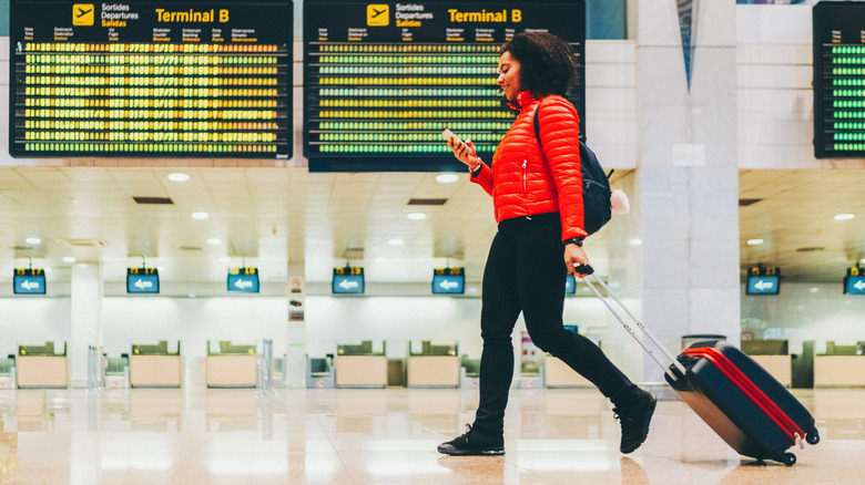 Woman pulling rolling suitcase