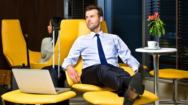 Man resting in airport lounge