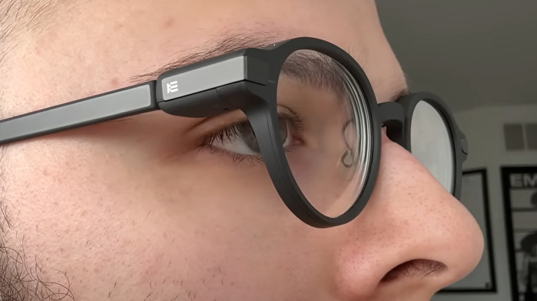 A man wearing black framed smart glasses
