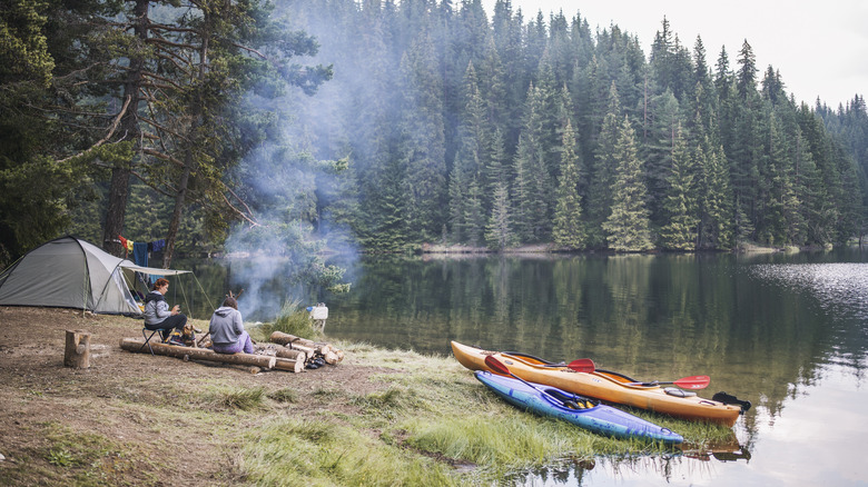 Friends tent-camping near a lake