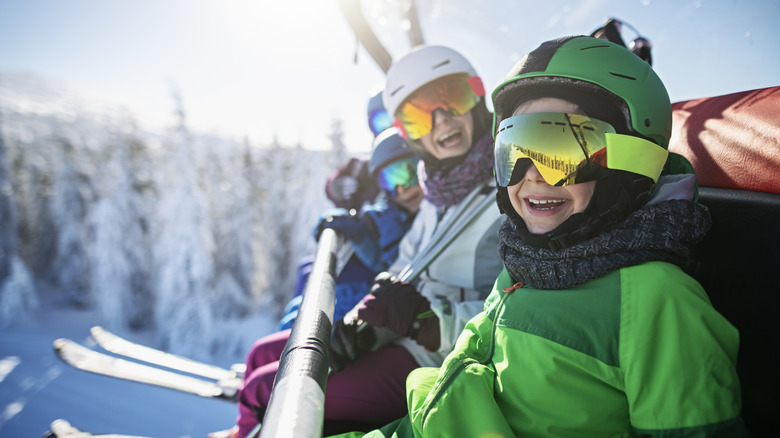 family smiling on ski lift