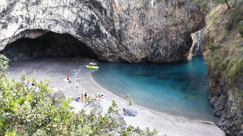 a small cove beach with transparent water