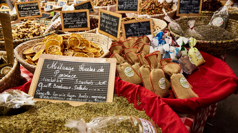 baskets of herbs and dried fruits at a market stall